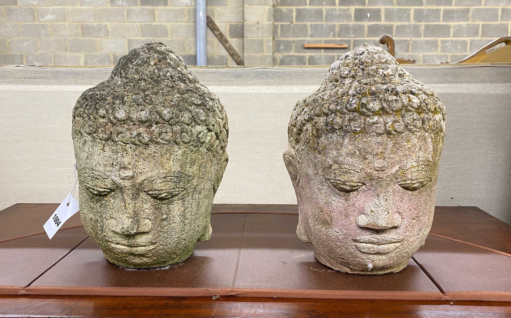 A pair of reconstituted stone 'Buddha' heads, height 35cm